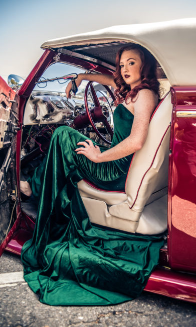 denver high school senior in a green velvet dress in an old red car