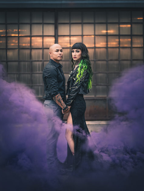 edgy couple with purple smoke wearing black