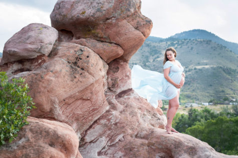 denver maternity and newborn portrait of mother in a blue dress on red rocks