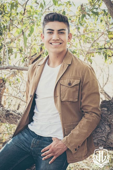 denver high school senior boy in a wooded setting with a tan jacket